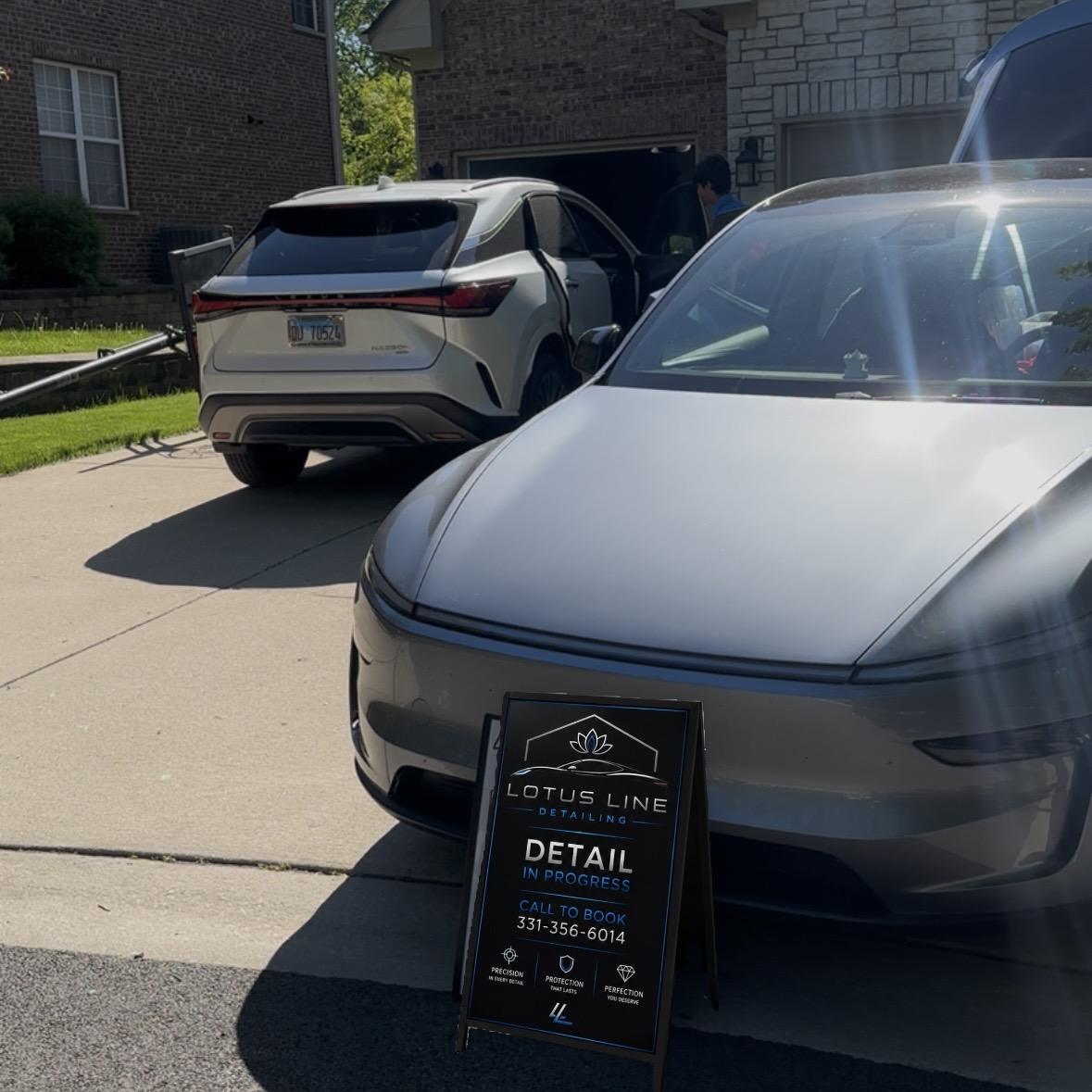 Mobile detailing setup at a residential location with professional equipment